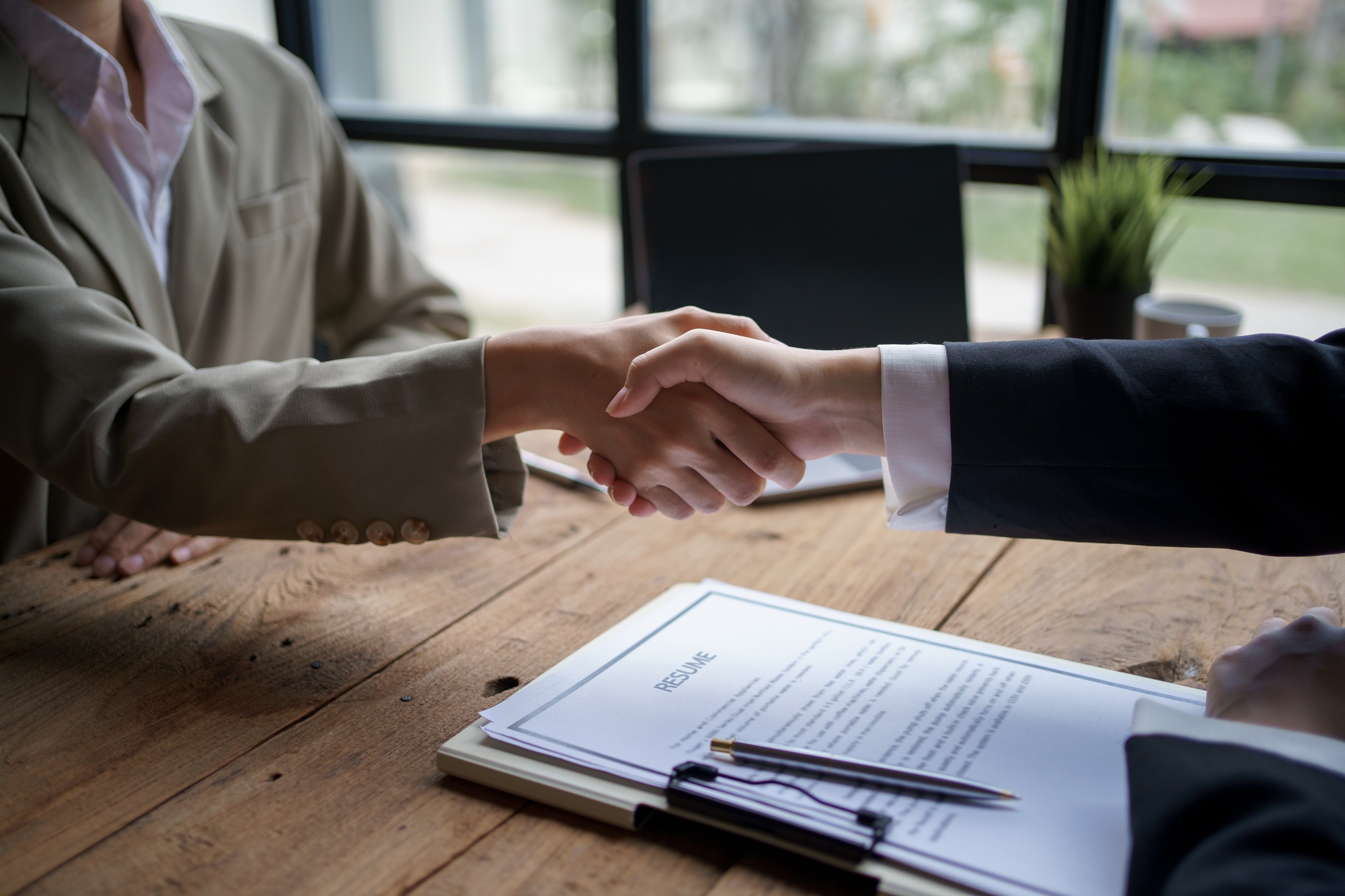 Asian Businesswoman shaking hands to confirm agreement in business for mutual investment