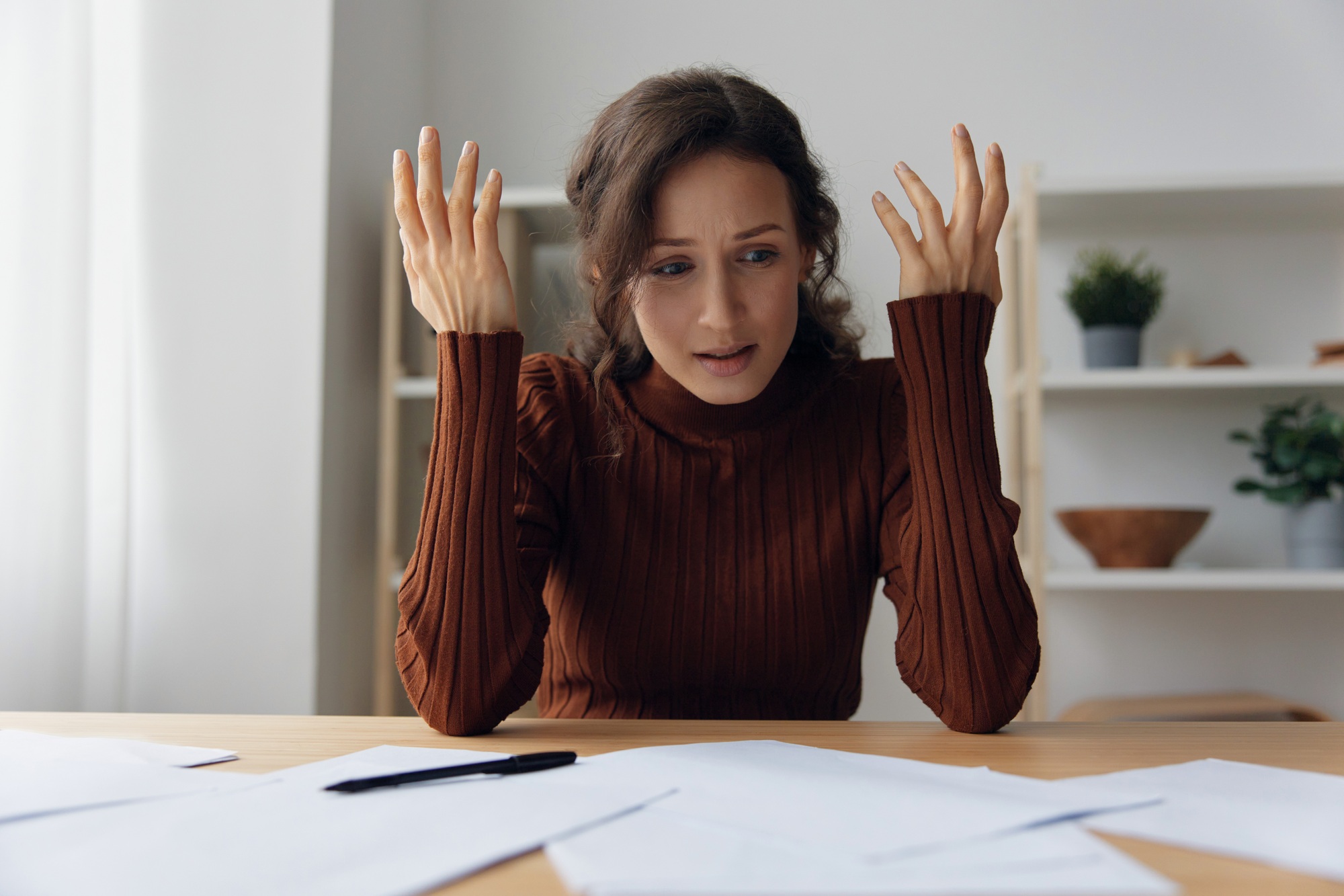 Financial troubles concept. Irritated angry evil curly pretty woman don't know what to do in life