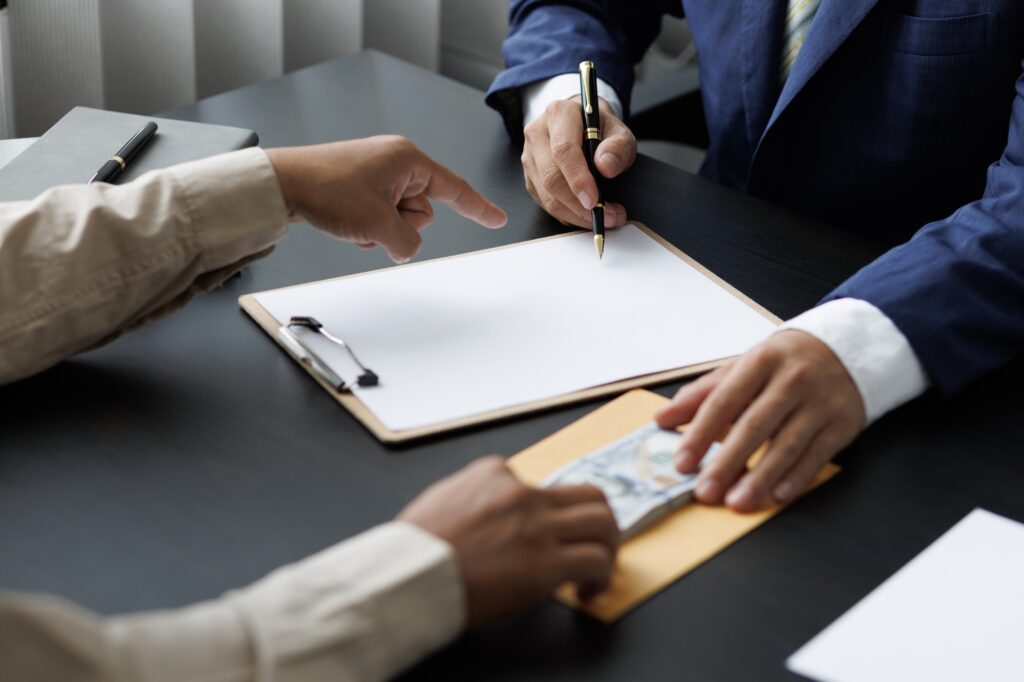Business people get paid wages or salaries. Bribery signing concept.