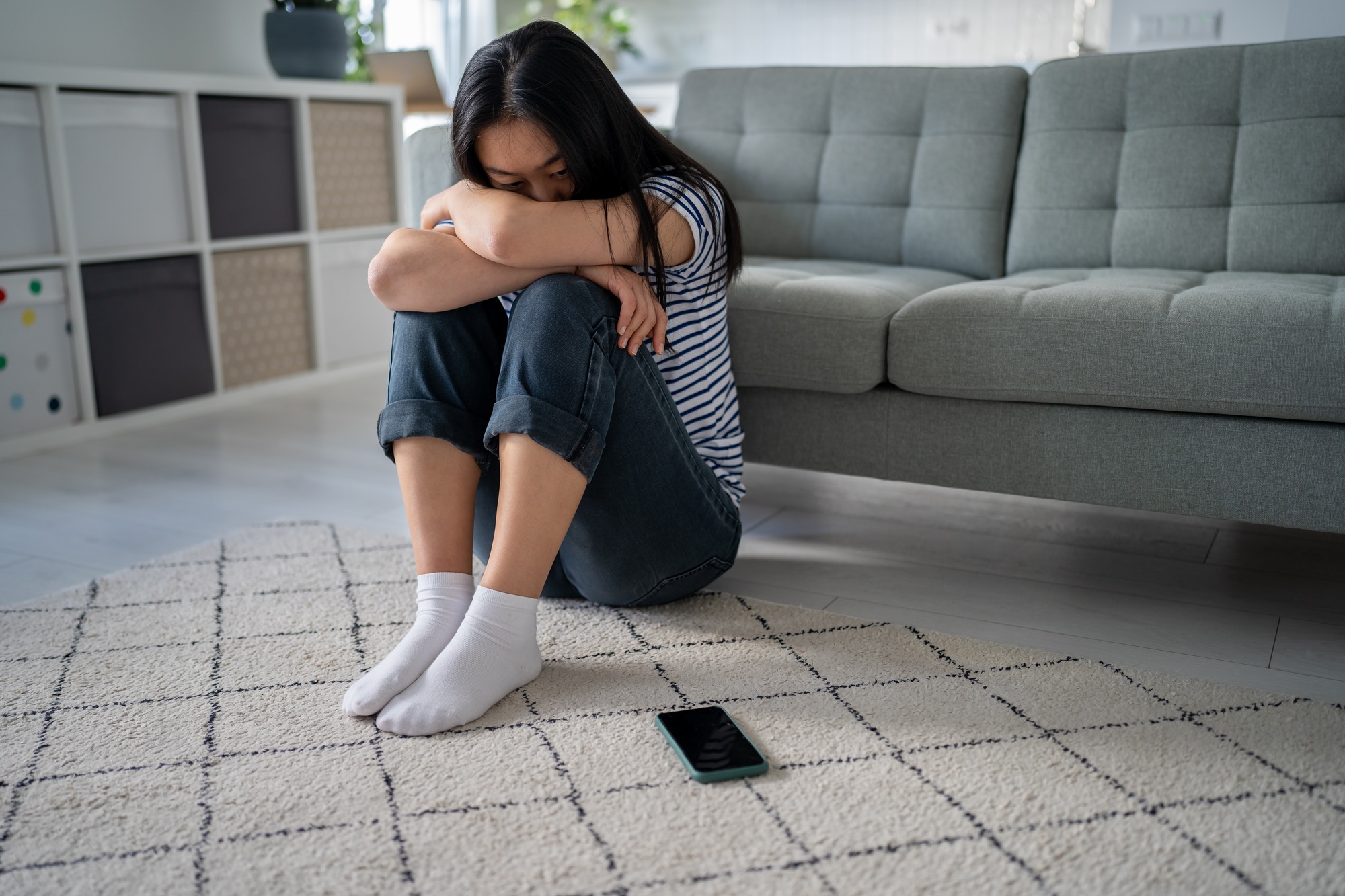 Lonely sad asian woman suffering on floor looks devastated mental trouble bad relationship breakup.